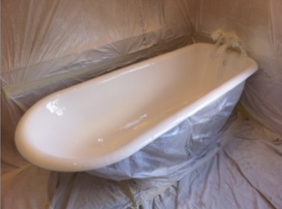A bath that has been resurfaced. The picture shows the masking around the bath and the room still in place.