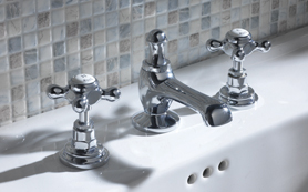 A white basin with 3 hole filler taps attache. tHE TAPS ARE IN cHROME.