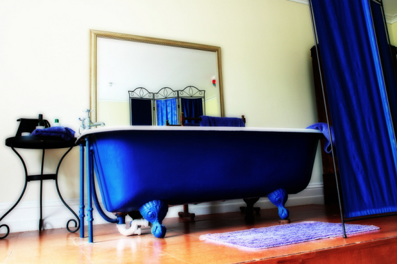 A lovely cast iron roll top bath in a bedroom