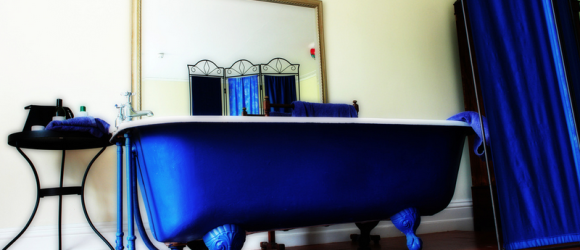 A lovely cast iron roll top bath in a bedroom